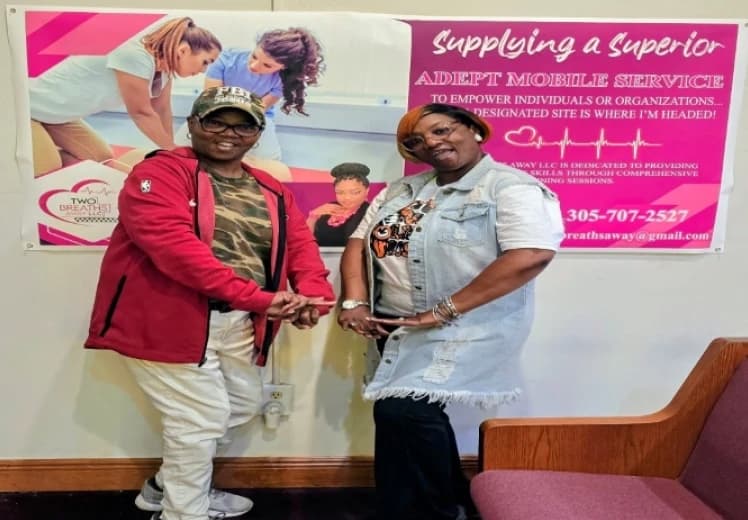 Two Breaths Away LLC instructor Ramona Hardy with a student after a CPR class in Miami, FL